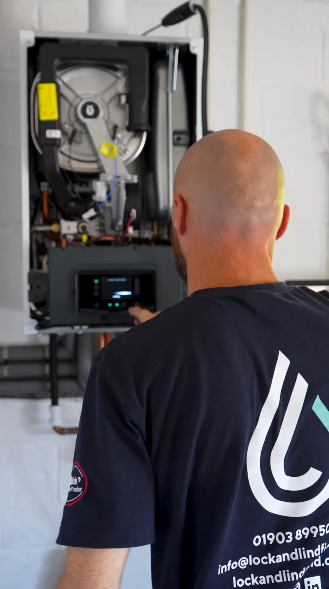 Lock & Lindfield engineer adjusting the controls of a newly installed boiler